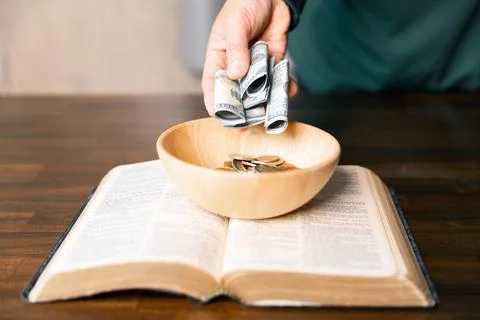 He decided to donate portion of his earnings as tithe, giving money and coi.. Stock Photos
