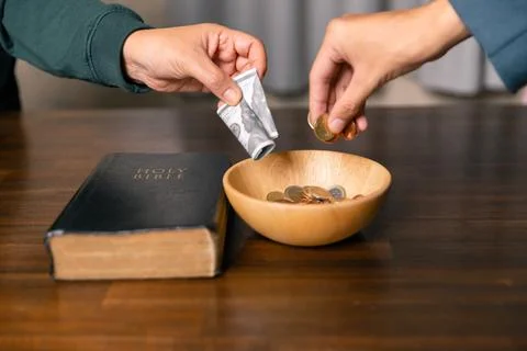 He decided to donate portion of his earnings as tithe, giving money and coi.. Stock Photos