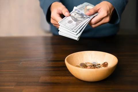 He decided to donate portion of his earnings as tithe, giving money and coi.. Stock Photos