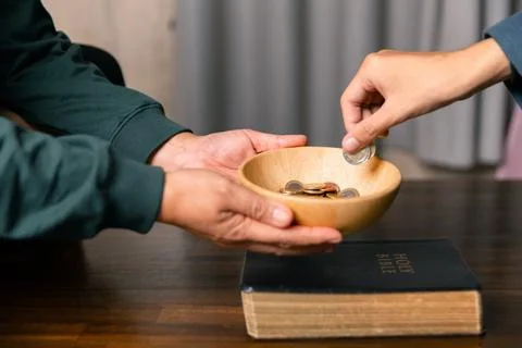 He decided to donate portion of his earnings as tithe, giving money and coi.. Stock Photos