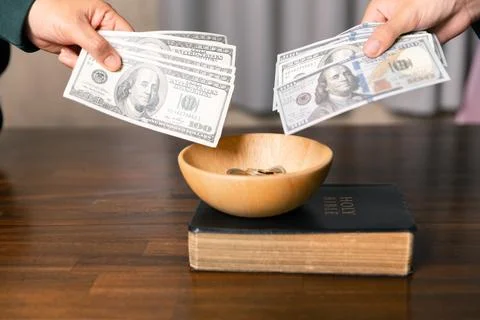 He decided to donate portion of his earnings as tithe, giving money and coi.. Stock Photos