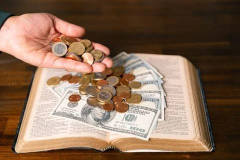 He decided to donate portion of his earnings as tithe, giving money and coi.. Stock Photos