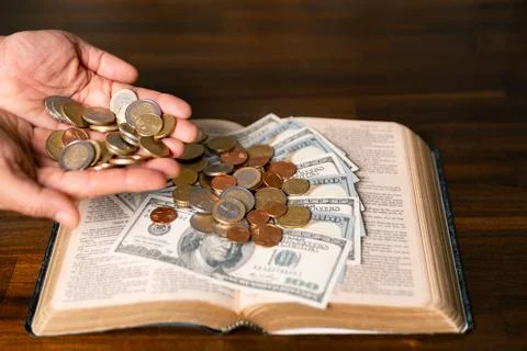 He decided to donate portion of his earnings as tithe, giving money and coi.. Stock Photos