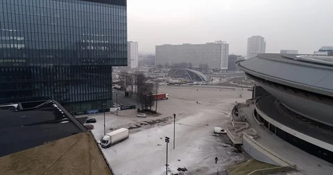 He drone passes between Spodek and the modern building. Video stock 106841892