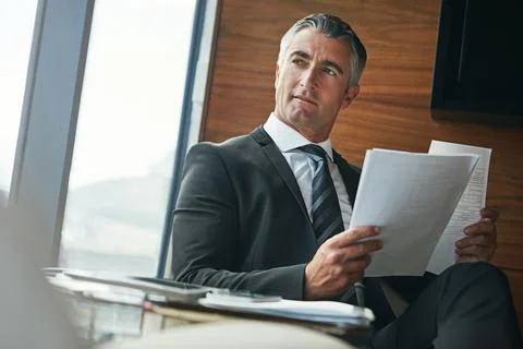 He focuses on solutions, not problems. a mature businessman going through Stock-Fotos