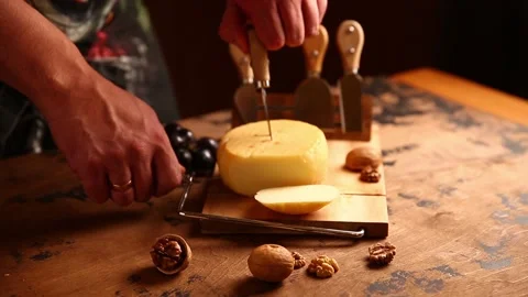 He hand cuts the hard cheese with a string Stock Footage 166944363