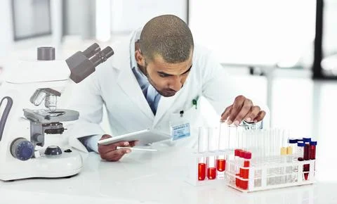 He has good practical and technical skills. Shot of a male scientist examining a Stock Photos