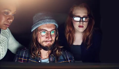 He has no problem working under pressure. a business team looking at a computer Stock Photos