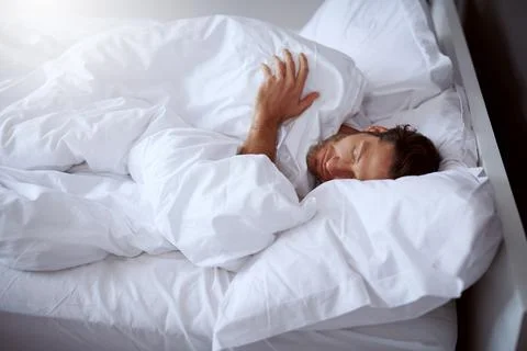 He has no problems with falling in sleep. a middle-aged man sleeping peacefully Stock Photos