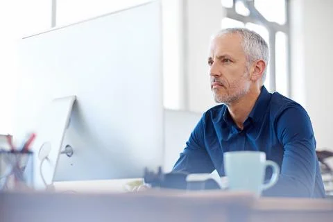 He has years of design experience behind him. Shot of a mature designer working Stock Photos