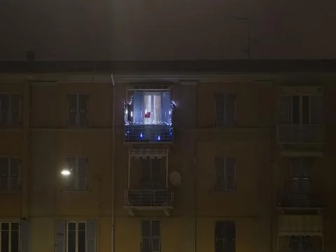 He light burns in one window of the multitude in a multi-storey residential.. Stock Photos