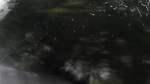 He looked through the window sprinkled drops of water falling on it during wa Stock Footage 78221400