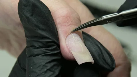 He manicure master in the salon cuts the cuticle. Manicure with a beauty salon Stock Footage 205524769