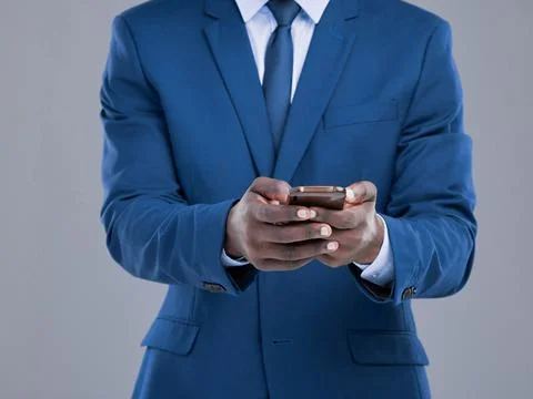 He never sends out mixed messages. an unrecognizable businessman checking his Stock Photos