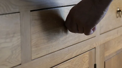 He opens a drawer and removes a box of matches Stock Footage 116998254