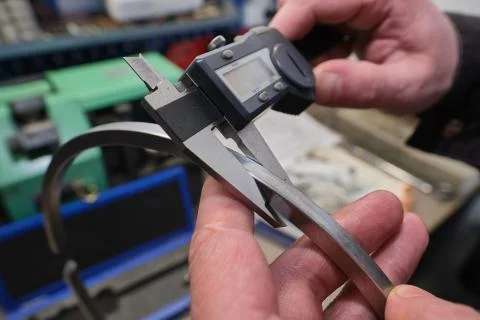 He process of measuring the thickness of a ring of a diesel engine using a ca Stock Photos