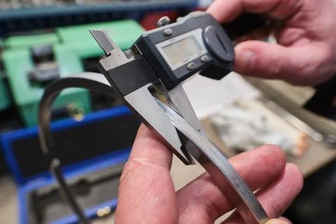 He process of measuring the thickness of a ring of a diesel engine using a ca Stock Photos