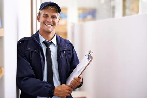 He provides a friendly and efficient service. a young man making a home delivery Stock Photos