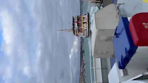 He stern of the ferry sails past - Stock vertical video Stock Footage 240298510