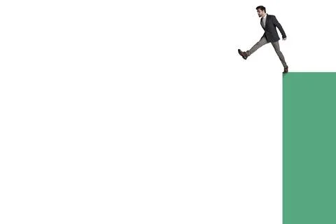 He took it one step too far. a businessman about to jump from the edge of a 스톡 사진