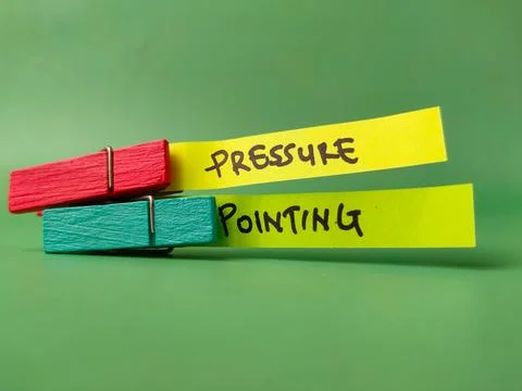 He top note, held by a red pin, has the word PRESSURE written on it.The bot.. Stock Photos