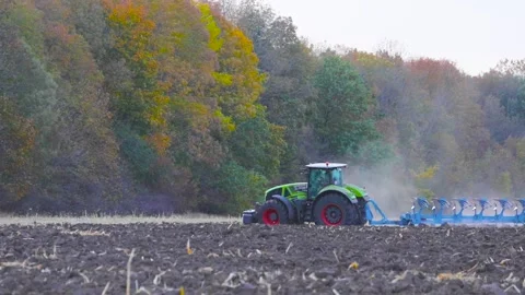 He tractor is processing the field. Processing the field with a tractor Stock Footage 145411187
