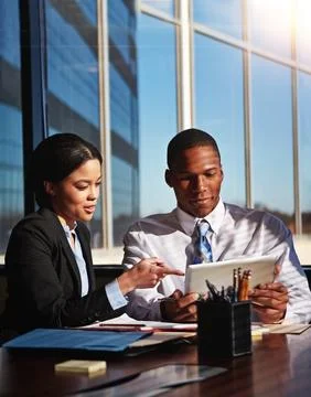 He values her input. two young businesspeople meeting in the boardroom. Foto stock