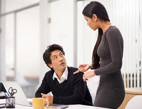 He values her input. two business colleagues working together in the office. Foto stock