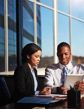 He values her opinion. two young businesspeople meeting in the boardroom. Foto stock
