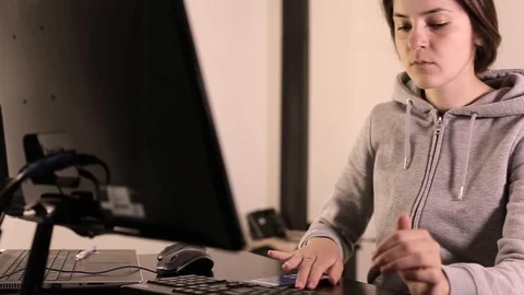 He works at the computer. Girl programmer. Programming training. The husband tea Stock-Footage 129434401