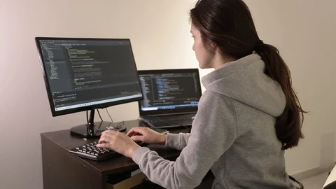 He works at the computer. Girl programmer. Programming training. The husband tea Stock-Footage 129434408