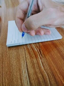 He writes something in a notebook with a pen. Foto stock