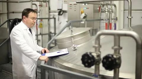 Head brewer checking vat of beer Stock Footage 21013794