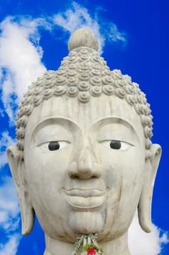 Head of Buddha Image and Cloudy Blue Sky Background Stock Photos
