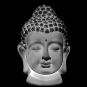 Head of Buddha statue on a black background Stock Photos