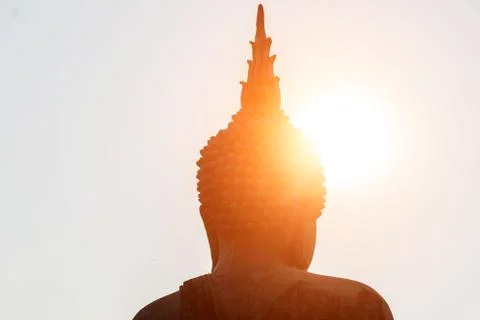 Head of buddha statue under the sun shines. Stock Photos