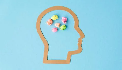 A head with a bunch of crumpled paper in the shape of a brain Stock Photos