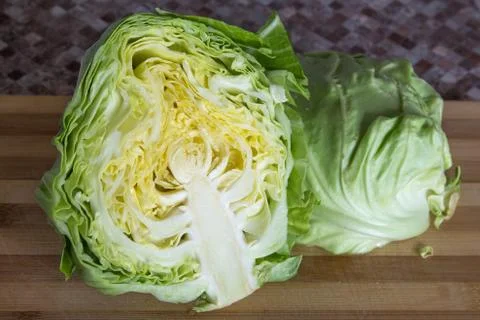 Head of cabbage cut in half on cutting board Stock Photos