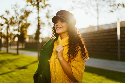 On the head cap on the shoulder put on the coat of the stylish beauty with a Stock Photos