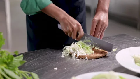Head chef in cooking school kitchen show chopping or slice vegetable skill .. Stock Footage 245085636