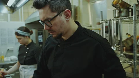 Head Chef Frying Fish with Bell Peppers at Work in Restaurant Kitchen Stock Footage 270145133