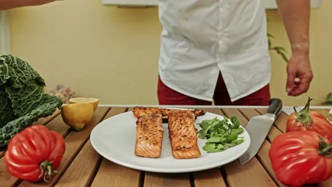 The head chef prepares a plate of grilled salmon with tomatoes and sprinkled Stock-Footage 203839238