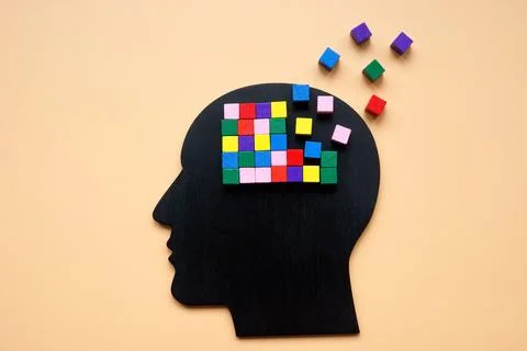A head with colored cubes, part of which is lost as a symbol of dementia. Stockfoto's