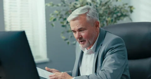 The head of company, elderly man with gray hair wearing an elegant jacket 動画素材 164874757