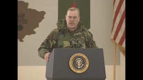 Head delegate of Task Force Falcon Troops welcomes Pres. Clinton on stage - 1999 Video stock 90453092