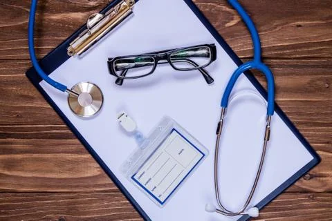 Head doctor's set: note, badge, stethoscope, glasses Stock Photos