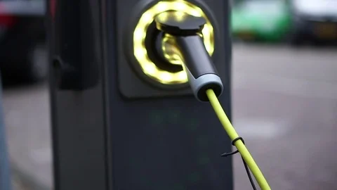 Head of electric car charging refueling station in Amsterdam city Stock Footage 85204944