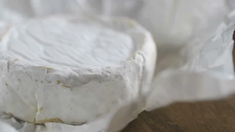 The head of the French cheese on the table on the gray background, rotate Stock Footage 90799747