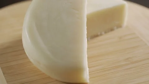 The head of the French cheese on the table on the gray background, rotate Video stock 92014532