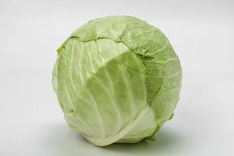 Head of fresh cabbage on a light background. Photo of food. Stock Photos